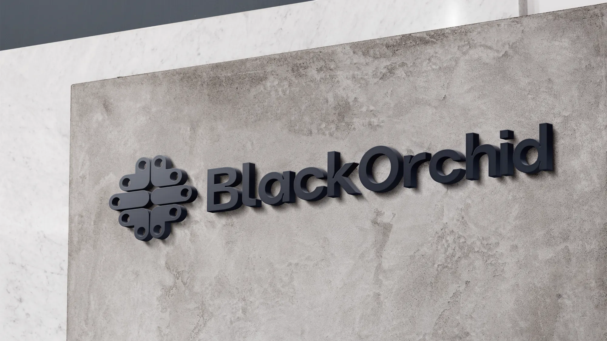 The BlackOrchid emblem and wordmark as a dimensional sign on a concrete wall