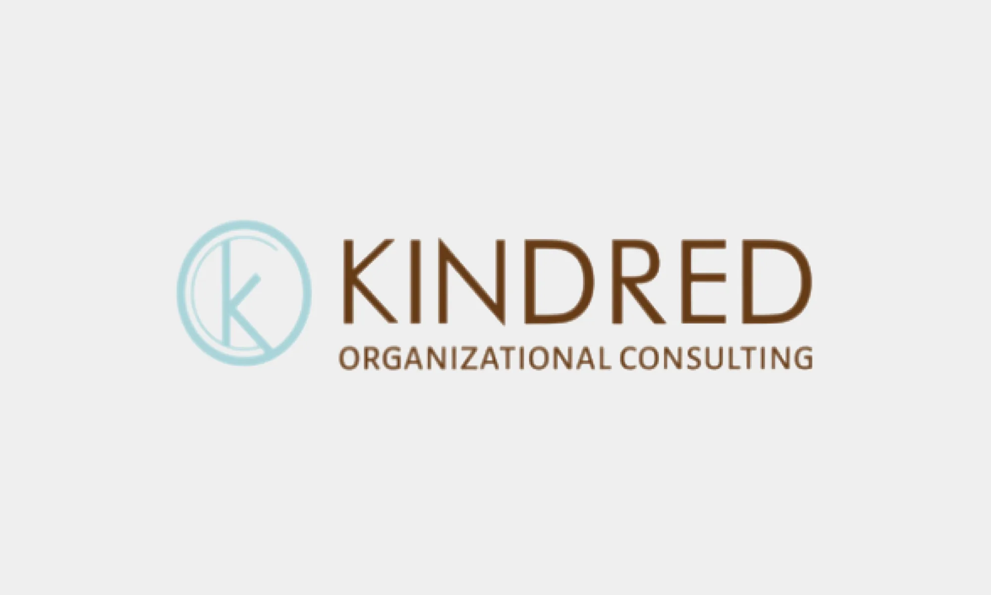 Kindred's original logo: a thin pale teal ring enclosing a K, beside the words Kindred Organizational Consulting in brown capitals.