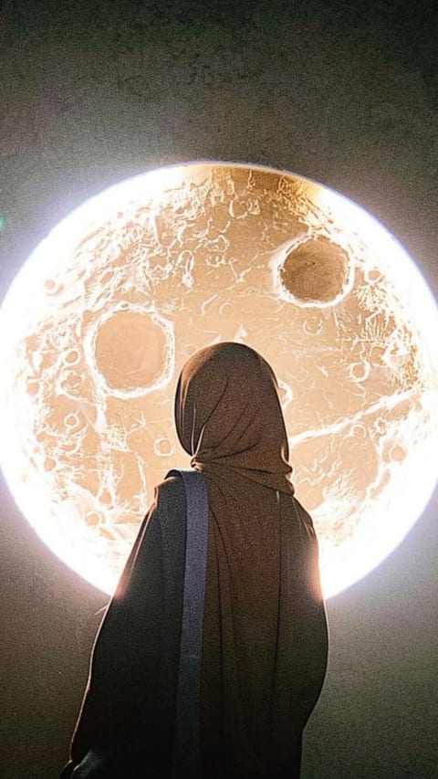 A woman in a hijab and abaya, seen from behind, silhouetted against a large glowing moon.